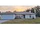 Single-story house with a white garage door and a neatly trimmed lawn at 3020 Kumquat Dr, Edgewater, FL 32141