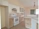 Kitchen features white cabinets and a tile floor at 3020 Kumquat Dr, Edgewater, FL 32141