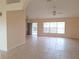 Open living room with tile floors and access to the patio at 3020 Kumquat Dr, Edgewater, FL 32141