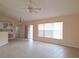 Living area with tile floors, sliding glass doors, and a ceiling fan at 3020 Kumquat Dr, Edgewater, FL 32141