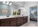 Double vanity bathroom with a view into the bedroom at 3037 Borassus Dr, New Smyrna Beach, FL 32168