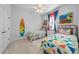 Bedroom with twin beds, colorful bedding, and beach-themed decor at 3037 Borassus Dr, New Smyrna Beach, FL 32168