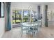 Bright dining area with a light blue table and chairs, near sliding glass doors at 3037 Borassus Dr, New Smyrna Beach, FL 32168