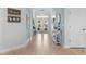 Long entryway with light wood floors and coastal decor at 3037 Borassus Dr, New Smyrna Beach, FL 32168