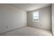 Simple bedroom with window, fresh paint, and concrete floors at 3055 Isles Way, New Smyrna Beach, FL 32168