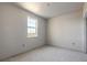 Bright bedroom with a window, fresh paint, and concrete floors at 3055 Isles Way, New Smyrna Beach, FL 32168