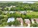 Aerial view of lakefront homes and surrounding landscape at 3084 Heartleaf Pl, Winter Park, FL 32792