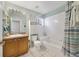 Clean bathroom with tub, shower, and wood vanity at 3084 Heartleaf Pl, Winter Park, FL 32792