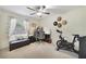 Bright bedroom featuring a home office setup, exercise bike, and ample natural light at 3084 Heartleaf Pl, Winter Park, FL 32792