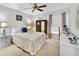 Bright bedroom with a queen-size bed, dresser, and ceiling fan at 3084 Heartleaf Pl, Winter Park, FL 32792