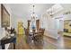 Dining room featuring hardwood floors, chandelier, and round table at 3084 Heartleaf Pl, Winter Park, FL 32792