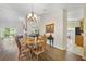 Bright dining room with hardwood floors and a view to kitchen at 3084 Heartleaf Pl, Winter Park, FL 32792