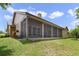 Home exterior showcasing a large screened porch and well-maintained lawn at 3084 Heartleaf Pl, Winter Park, FL 32792