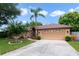 House exterior with two-car garage and landscaping at 3084 Heartleaf Pl, Winter Park, FL 32792