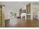 Bright living room featuring hardwood floors, a fireplace, and access to the backyard at 3084 Heartleaf Pl, Winter Park, FL 32792