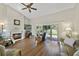 Living area with fireplace, hardwood floors and view of backyard at 3084 Heartleaf Pl, Winter Park, FL 32792