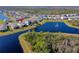 Picturesque aerial view of a home nestled in a community with a serene pond and lush green surroundings at 3191 Crab Trap Dr, New Smyrna Beach, FL 32168