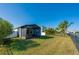 Screened patio, grassy backyard with a view of a canal at 3191 Crab Trap Dr, New Smyrna Beach, FL 32168