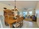 Dining room with wooden table, chairs, and a rustic chandelier at 3191 Crab Trap Dr, New Smyrna Beach, FL 32168