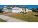 Charming single-Gathering home featuring a brick driveway, green lawn, and white exterior at 3191 Crab Trap Dr, New Smyrna Beach, FL 32168