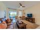 Living area featuring a leather sofa, armchairs, and sliding glass doors to patio at 3191 Crab Trap Dr, New Smyrna Beach, FL 32168