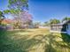 Backyard view of home with screened porch at 3220 Tamarind Dr, Edgewater, FL 32141