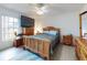 Main bedroom with king bed, large TV and dresser at 3220 Tamarind Dr, Edgewater, FL 32141