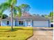 Ranch style home with palm trees and garage at 3220 Tamarind Dr, Edgewater, FL 32141