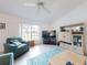 Bright living room with teal furniture and large windows at 3220 Tamarind Dr, Edgewater, FL 32141