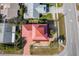 Aerial view of a charming two-story house with a red metal roof and a spacious yard at 3726 S Atlantic Ave, New Smyrna Beach, FL 32169