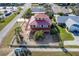 An elevated view showcasing a house with a red roof, deck, and a fenced yard at 3726 S Atlantic Ave, New Smyrna Beach, FL 32169