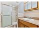 Clean bathroom with a shower, granite vanity, and medicine cabinet at 3726 S Atlantic Ave, New Smyrna Beach, FL 32169