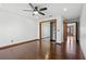 Bright bedroom with wood floors, mirrored closet, and access to a hallway at 3726 S Atlantic Ave, New Smyrna Beach, FL 32169