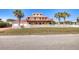 Two-story beach house with red roof and white fence at 3726 S Atlantic Ave, New Smyrna Beach, FL 32169