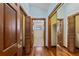 Hardwood floor hallway with mirrored and louvered doors at 3726 S Atlantic Ave, New Smyrna Beach, FL 32169