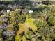 Aerial view of property showing home nestled in the trees at 384 W Ariel Rd, Edgewater, FL 32141