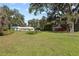 Spacious backyard with a detached barn and large oak trees at 384 W Ariel Rd, Edgewater, FL 32141