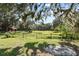 Serene backyard with lush grass and mature trees at 384 W Ariel Rd, Edgewater, FL 32141