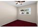 Bedroom with red carpet and large window at 384 W Ariel Rd, Edgewater, FL 32141