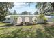 Front entrance with arched entryway and mature landscaping at 384 W Ariel Rd, Edgewater, FL 32141