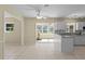 Bright kitchen with white cabinets, tile floors, and view into adjacent living area at 384 W Ariel Rd, Edgewater, FL 32141