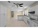 Clean kitchen showcasing white cabinets, gray countertops, and tile floor at 384 W Ariel Rd, Edgewater, FL 32141