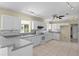 Modern kitchen with white cabinets, gray countertops, and tile flooring at 384 W Ariel Rd, Edgewater, FL 32141