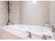 Relaxing bathtub with tiled surround, perfect for soaking at 3851 S Atlantic Ave # 701, Daytona Beach Shores, FL 32118