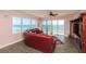 Living room with ocean view, leather sectional sofa, and hardwood floors at 3851 S Atlantic Ave # 701, Daytona Beach Shores, FL 32118