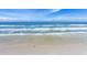 Aerial view of beach with ocean waves and two people walking at 3855 S Atlantic Ave # 1105, Daytona Beach Shores, FL 32118