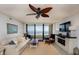 Living room with ocean view and ceiling fan at 3855 S Atlantic Ave # 1105, Daytona Beach Shores, FL 32118