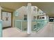 Condo hallway with light-colored walls and a teal railing at 4 Oceans West Blvd # 502B, Daytona Beach, FL 32118