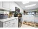 Bright kitchen with white cabinets, stainless steel appliances, and a decorative rug at 4 Oceans West Blvd # 502B, Daytona Beach, FL 32118