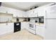 Well-equipped galley kitchen featuring white cabinetry and modern appliances at 4 Oceans West Blvd # 502B, Daytona Beach, FL 32118